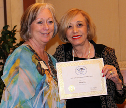 Sheila Roe receiving two awards